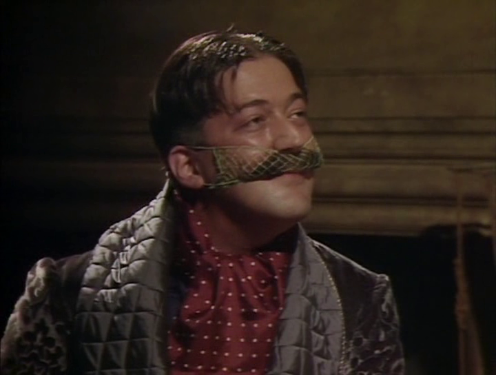 General Melchett wearing a moustache net