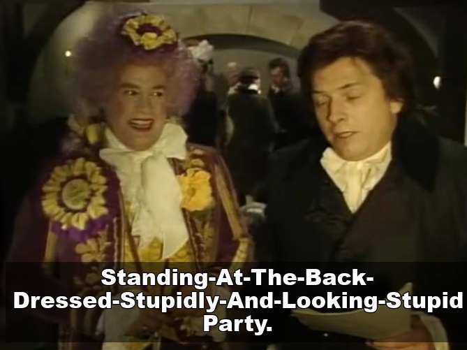 Standing at the back dressed stupidly